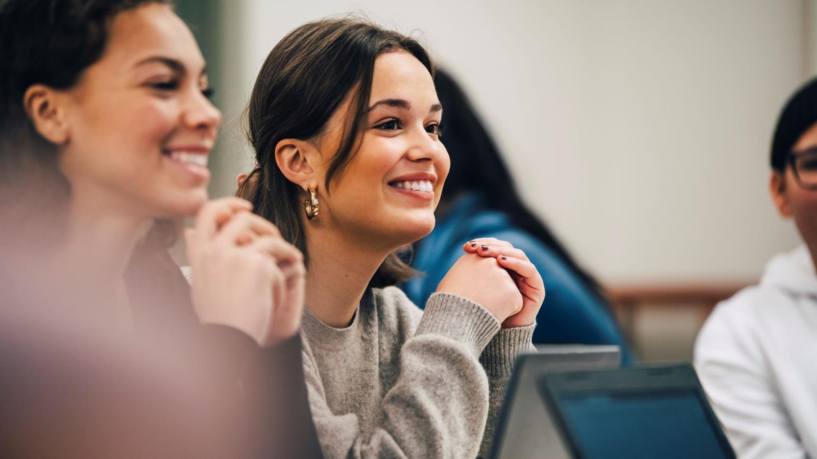 Women Smiling In Meeting Or Class Setting Right