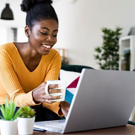Woman Working On Lap[Top With Yellow Shirt
